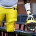 A Michigan player grabs his hemet during the spring football game on Saturday, April 13. AnnArbor.com I Daniel Brenner